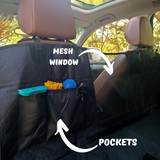 dog backseat cover installed in the car focusing on the opening in the middle front and the pockets that fit toys and leashes