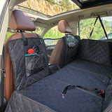 Frontal view of the PetSouks hard bottom seat cover installed in an SUV showing seatbelt opening and pockets with mesh window
